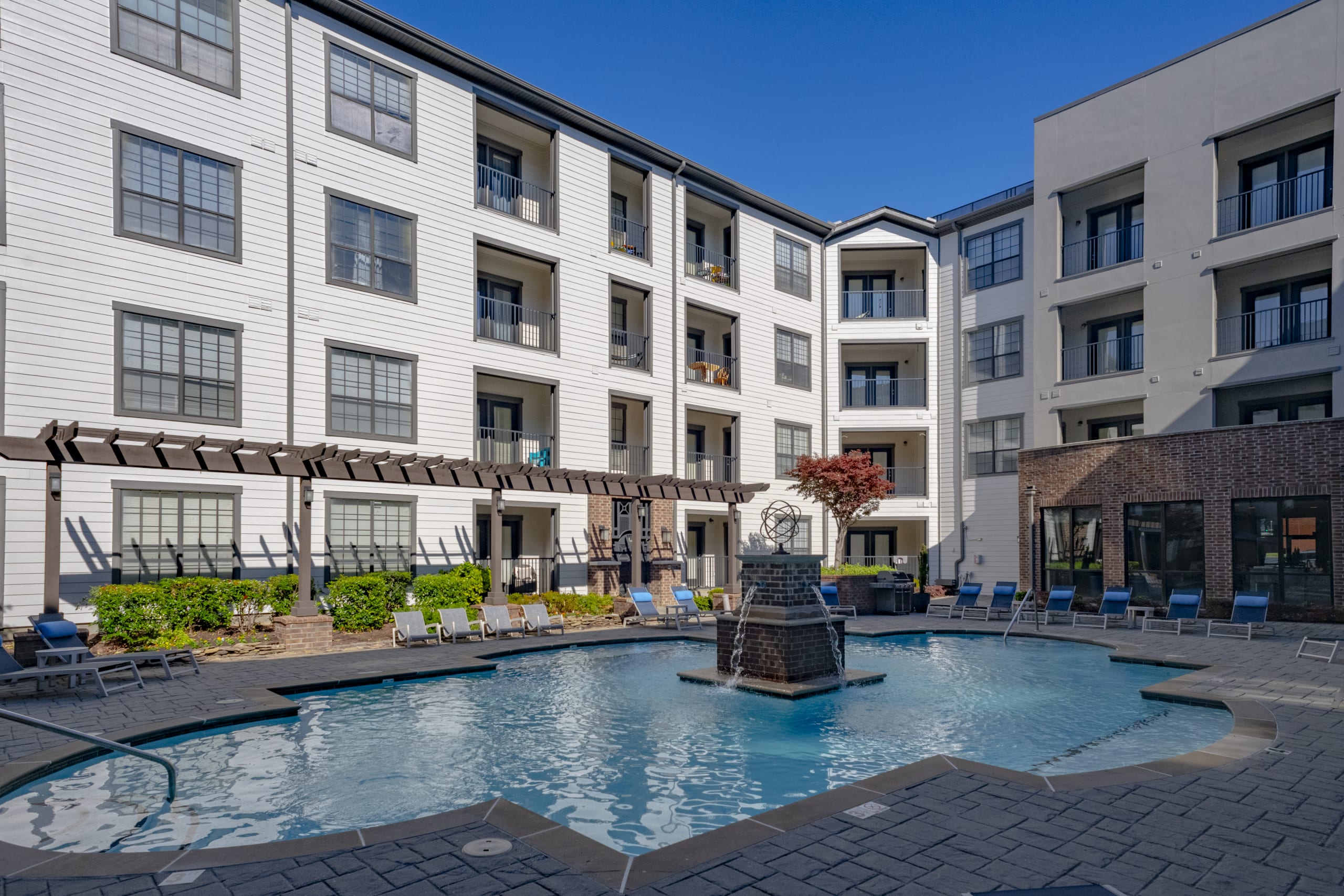 Swimming pool courtyard surrounded by apartment buildings.
